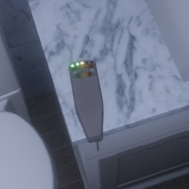 Phasmophobia EMF reader with 2 green leds and 1 yellow lit on the counter of the bathroom