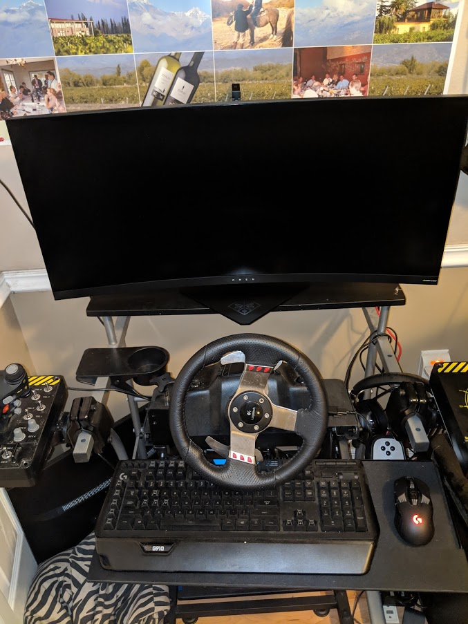 My old cobbled together gaming desk made of VESA arms and mounts with an ultrawide monitor, hotas and steering wheel