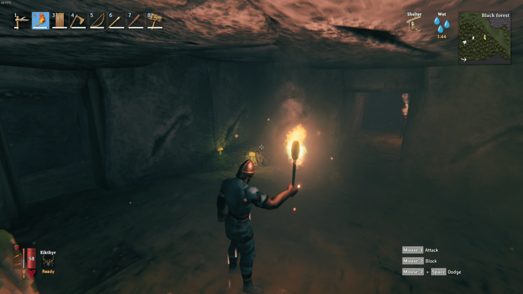 Valheim exploring burial chamber using a torch for llght