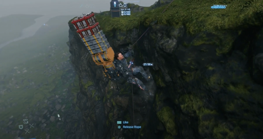 Death Stranding Sam Porter carrying a large stack of cargo up a mountain using rope