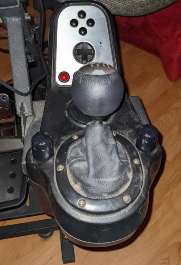 Logitech g27 Shifter mounted on the side of a wheel stand