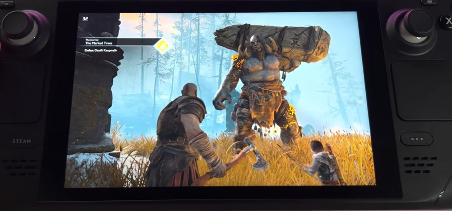 God of War Kratos with axe in hand with Atreus holding a bow and giant in the background on Steam Deck