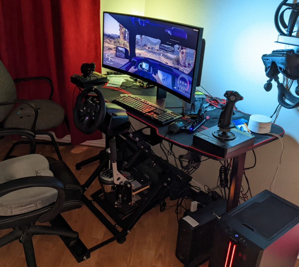 PC gaming desk with wide screen monitor, hotas, racing wheel, shifter and handbrake