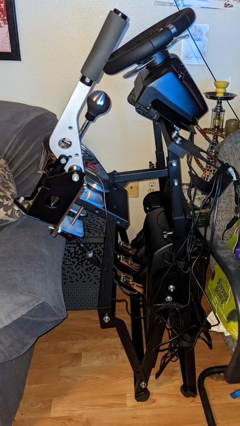 Logitech G920 wheel stand folded all the way up with wheel, pedals, shifter and handbrake