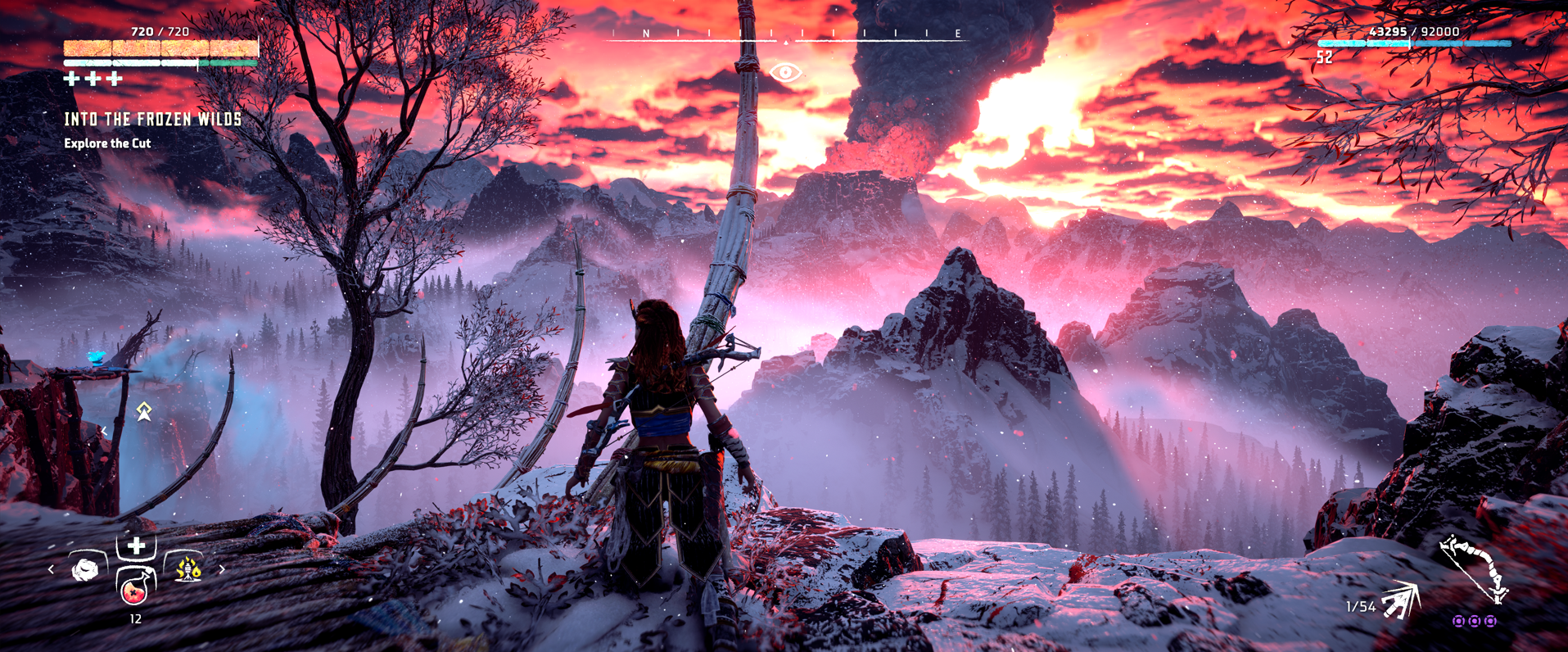 Horizon Zero Dawn Frozen Wilds DLC Aloy watching the volcano eruption with icy mountains in the background