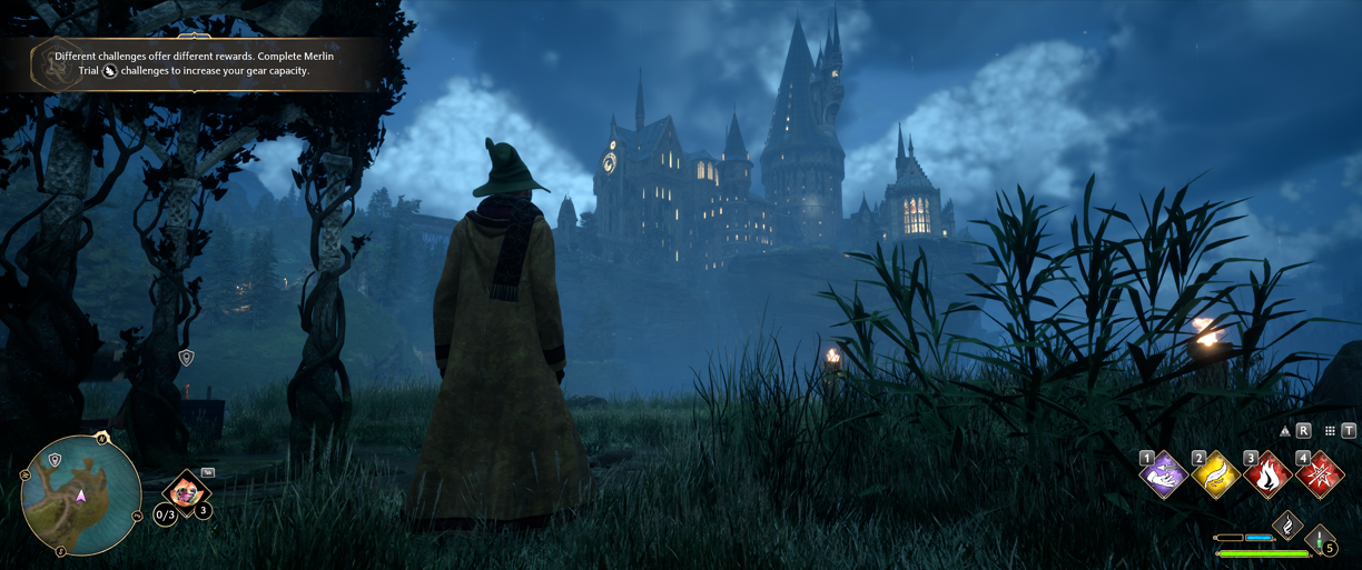 Hogwarts Legacy Game Wizard looking at the Hogwarts School at night