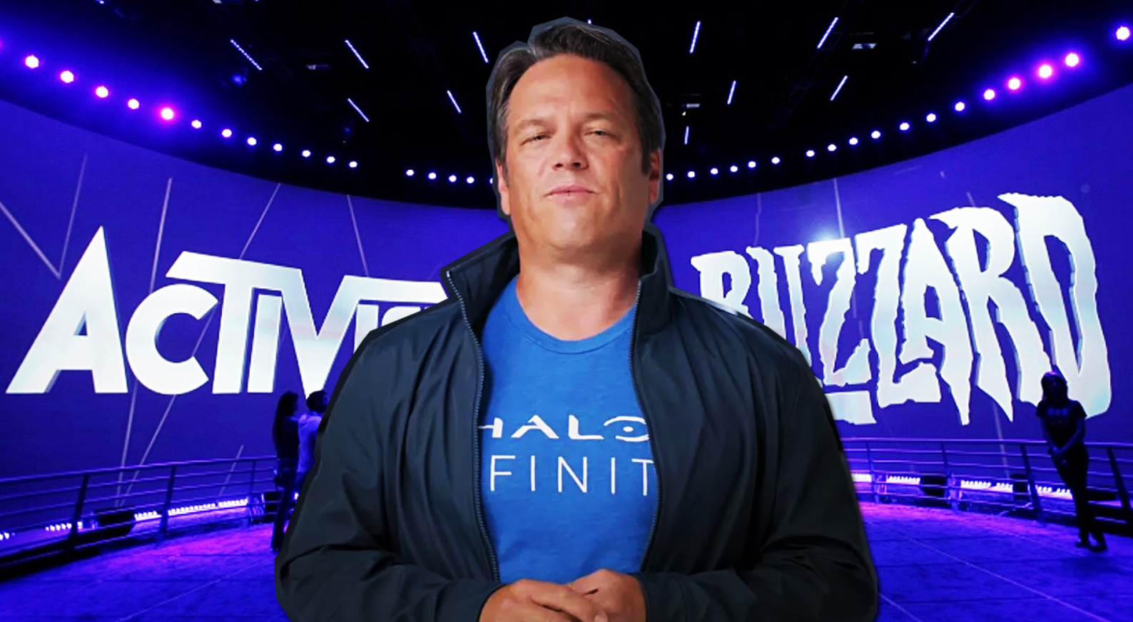 Phil Spencer wearing a Halo Infinite shirt with Activision Blizzard behind him