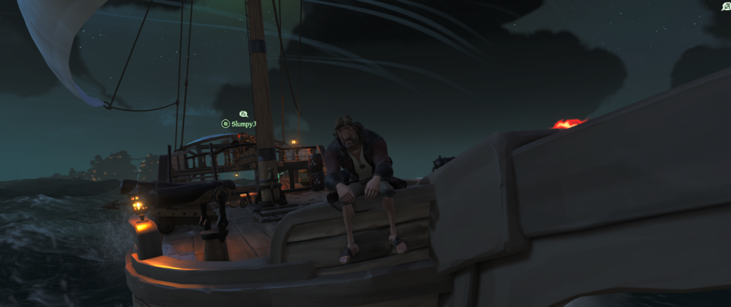Sitting on the boat at night on the Sea of Thieves