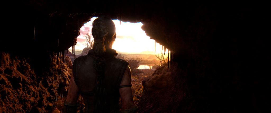 Senua emerging from a cave into the sunlight