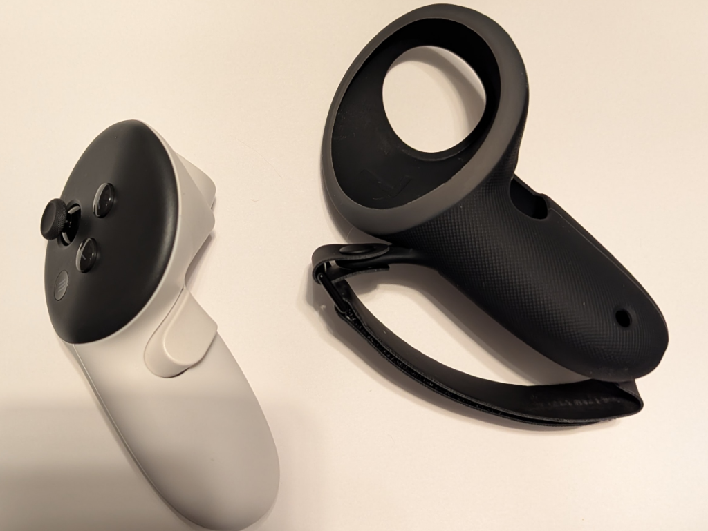 Kiwi Quest 3 black silicone grip in valve index style next to a Quest 3 controller